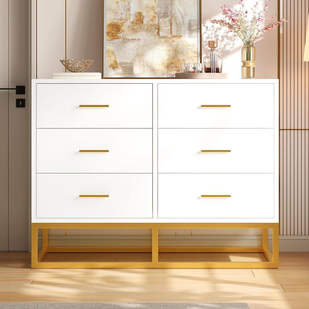 White dresser with gold legs in a styled room.