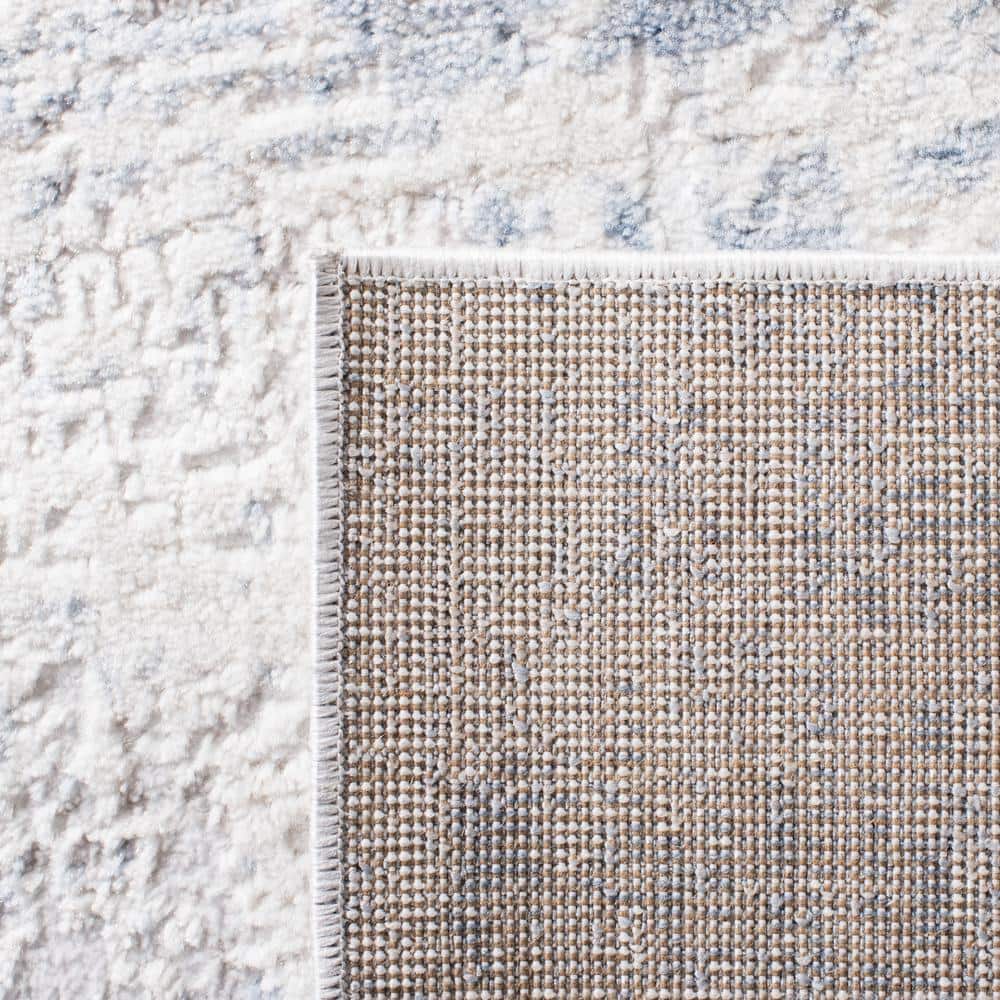 Ivory and Blue Abstract 8' x 10' Synthetic Area Rug
