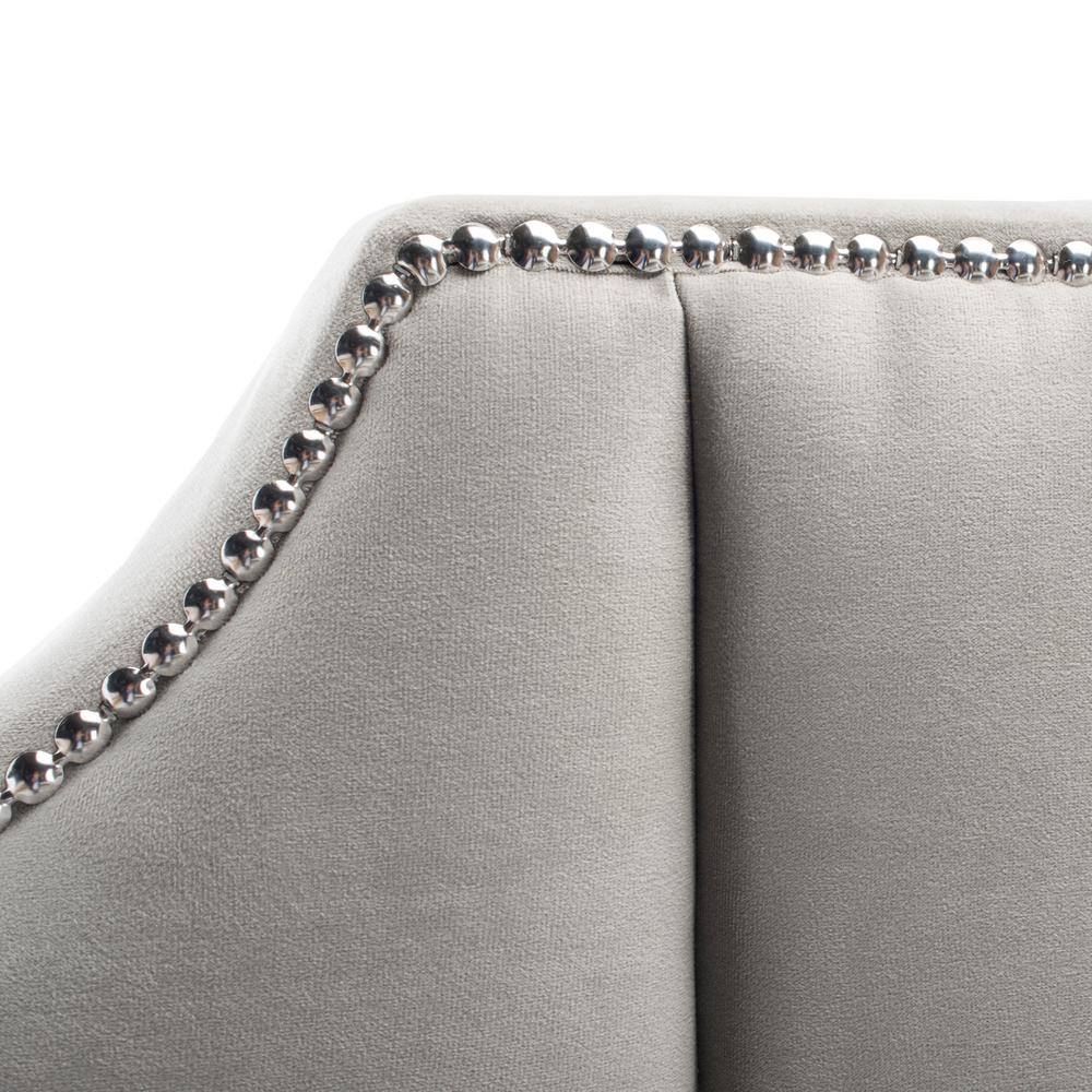 Close-up detail of the studded trim on the upholstered headboard.
