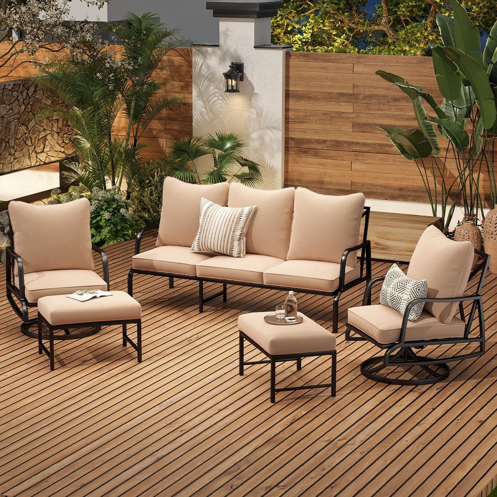 Outdoor patio set arranged on a wooden deck with greenery.
