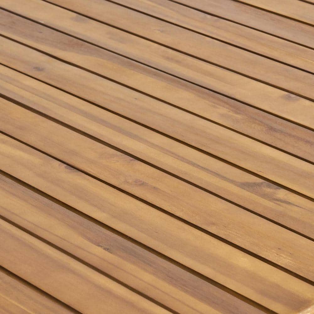 Close-up of the slatted teak wood tabletop surface