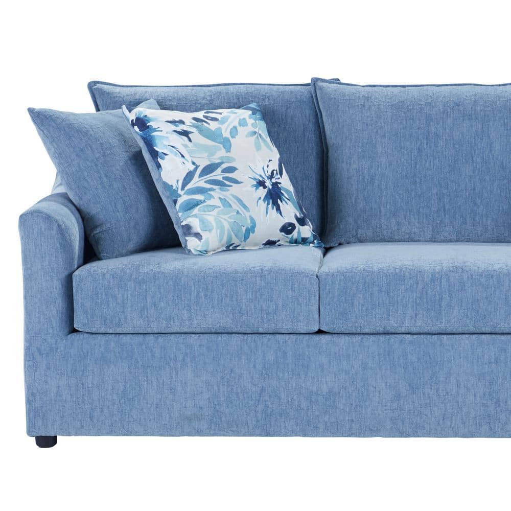 Close-up of the slate blue sofa and floral pillow.