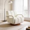 White bouclé fabric swivel accent arm chair positioned near a window.