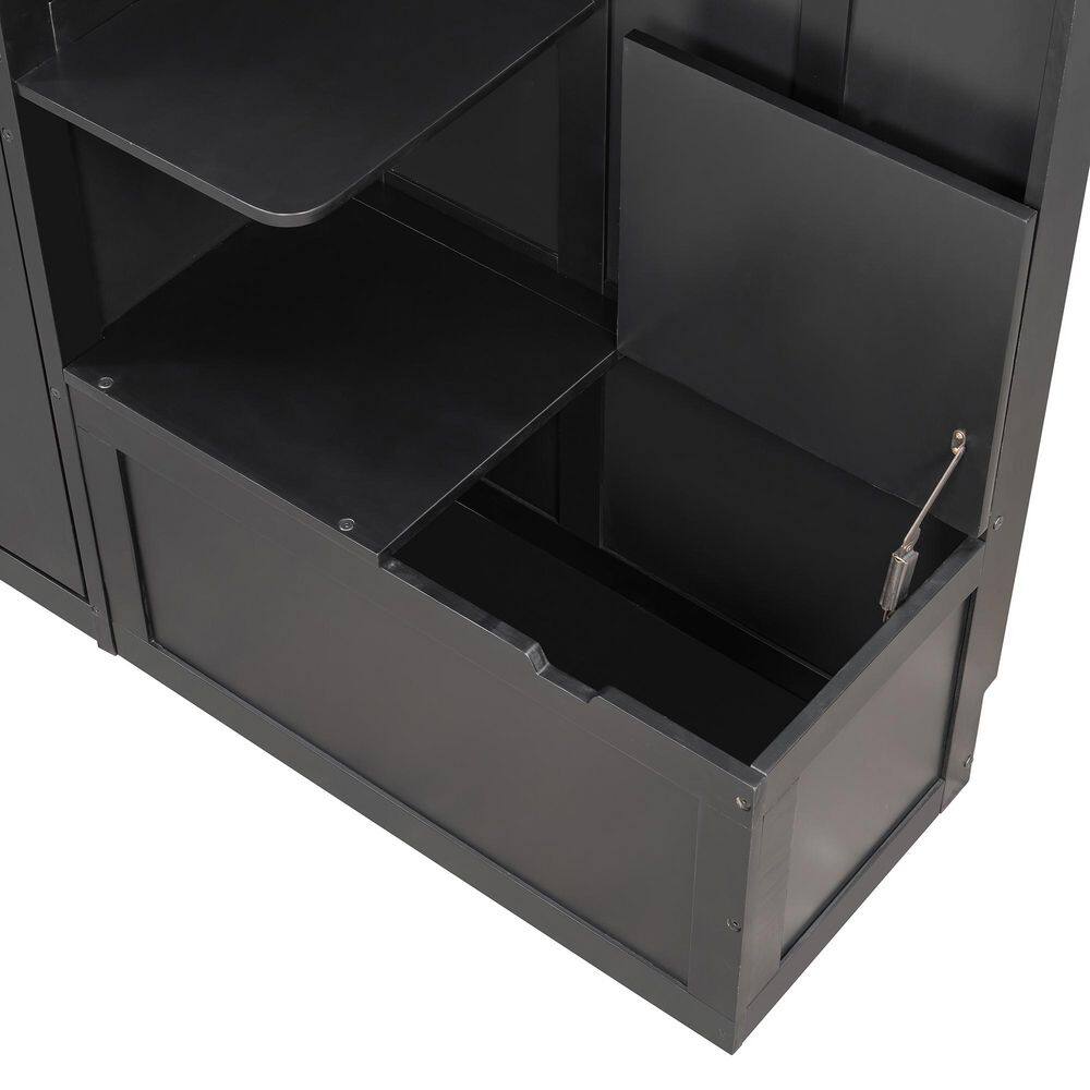 Detail of the black storage cabinet with an open door and gas lift hinge.