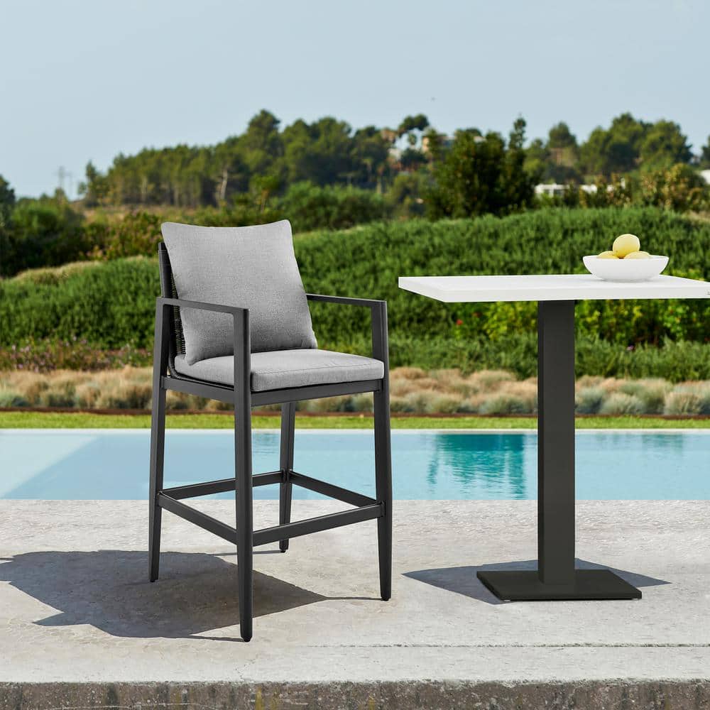 Sleek Aluminum and Rattan Outdoor Bar Stool with Dark Grey Cushions