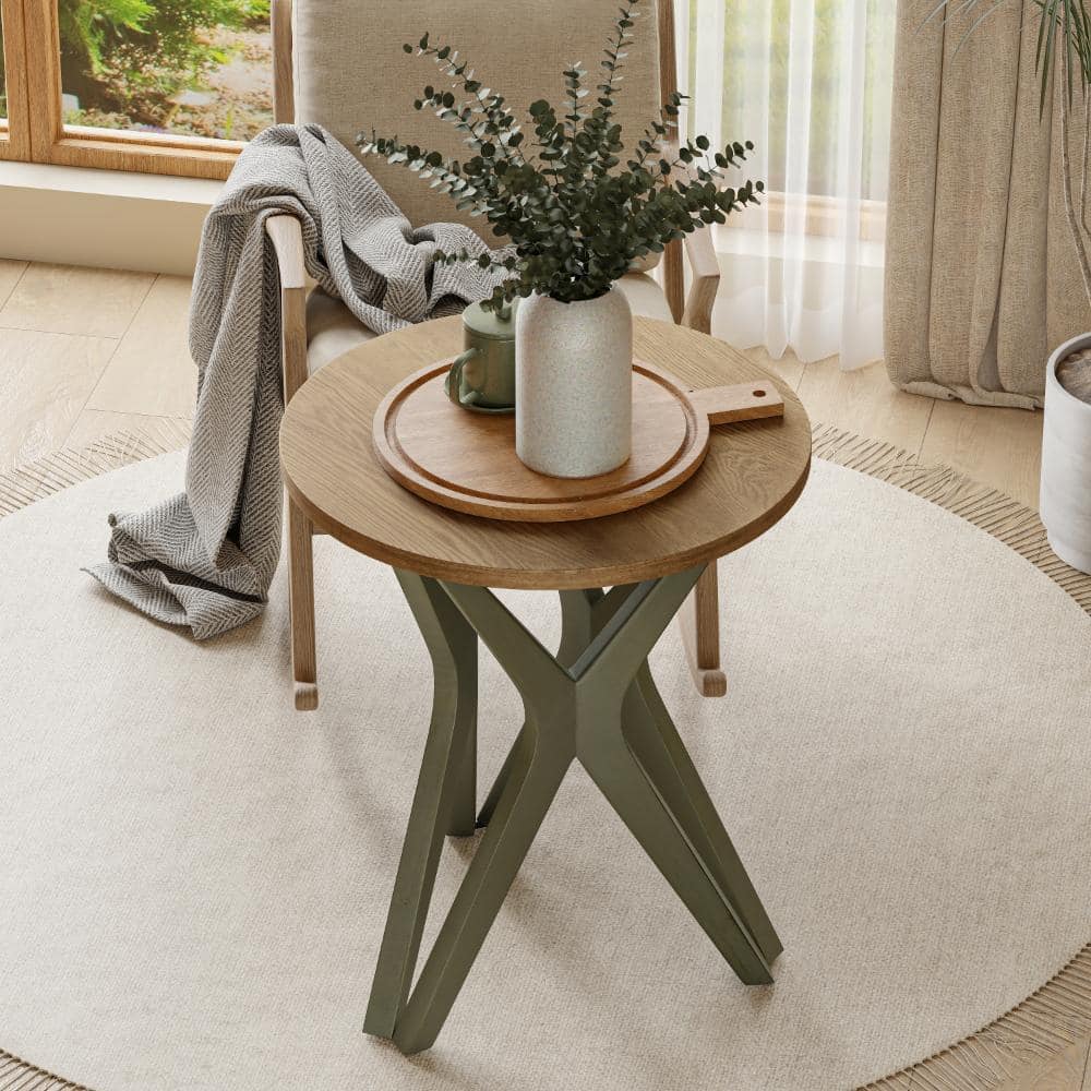 Green end table next to a window with plants and curtains.