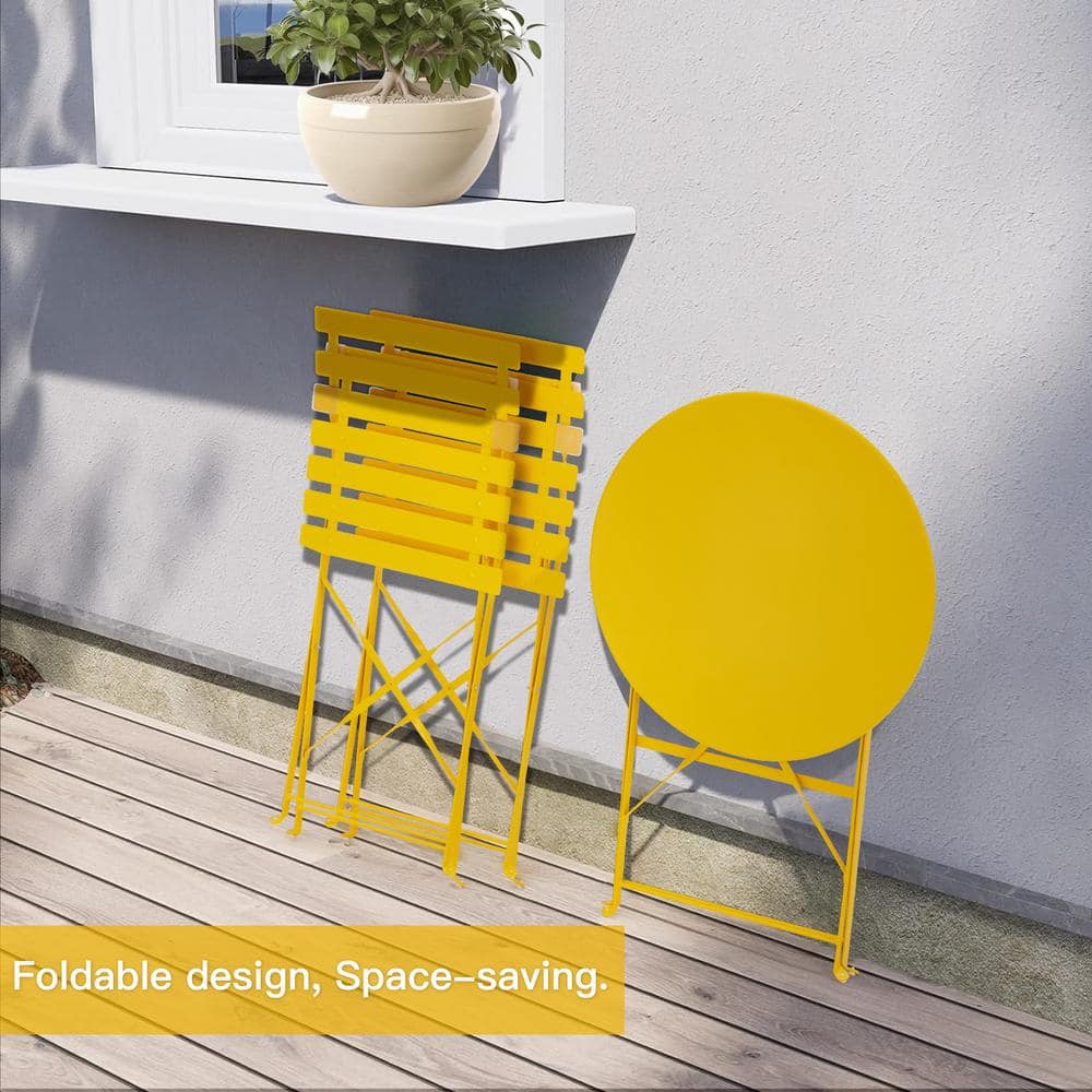 Yellow folding bistro table and two folded chairs.