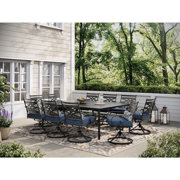Hanover Montclair 11-Piece Steel Outdoor Dining Set with Navy Blue Cushions, 10 Swivel Rockers and 60 in. x 84 in. Table