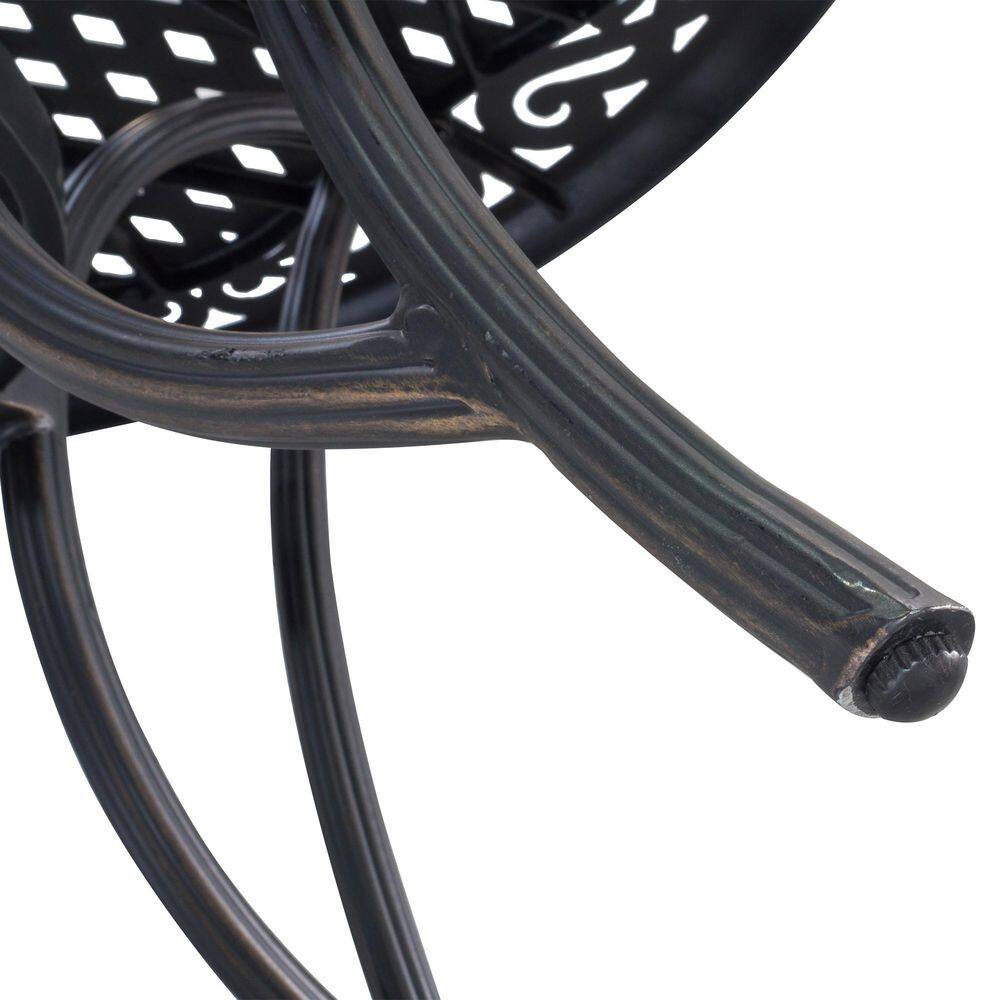 Close-up of the curved leg and foot of the dark bronze table.