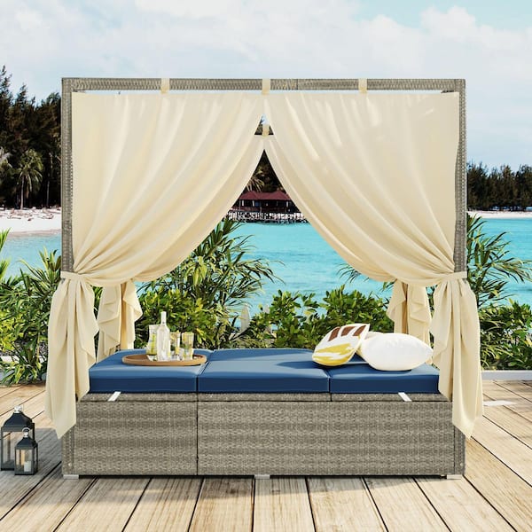Wicker Outdoor Day Bed with Blue Cushions and Curtain