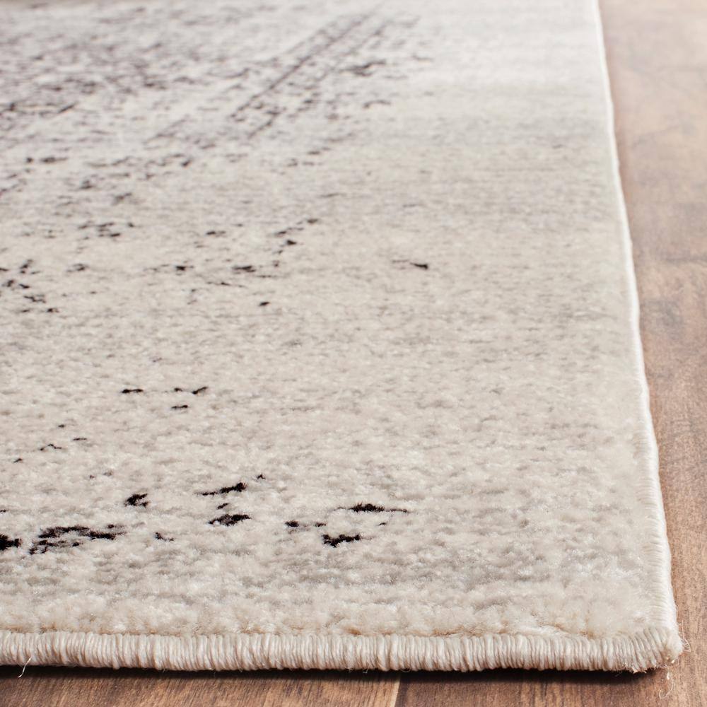 Ivory and Black Floral Motif Synthetic Area Rug