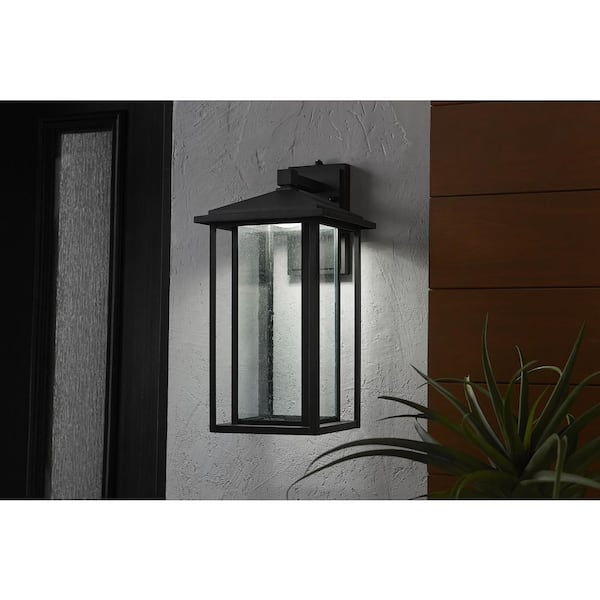Home Decorators Collection Mauvo Canyon 18 in. Black Dusk to Dawn Large LED Outdoor Wall Light Fixture Sconce with Seeded Glass
