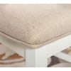 Close-up of the beige upholstered seat on a Twyla dining chair.