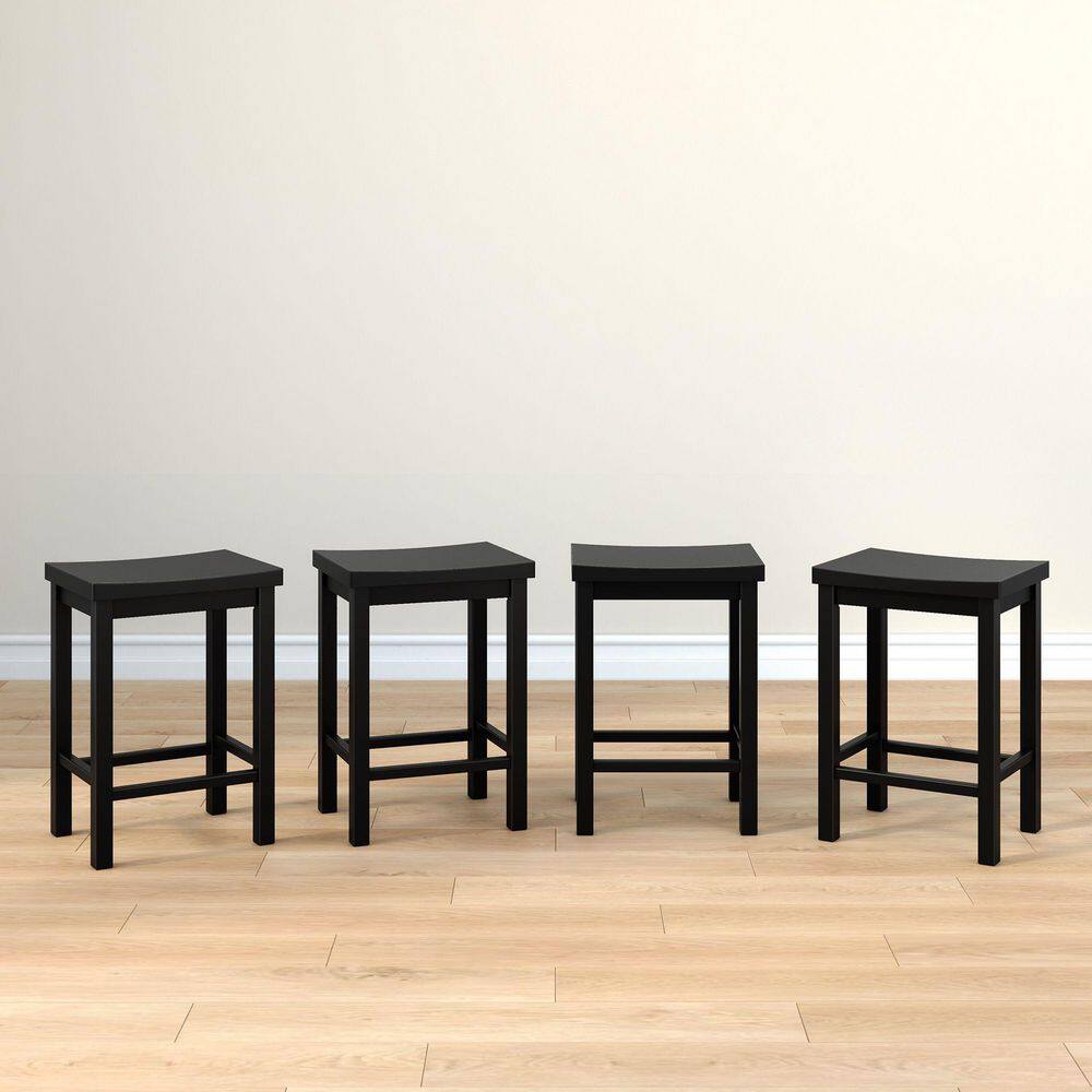 Four black backless wood counter stools lined up in a row.
