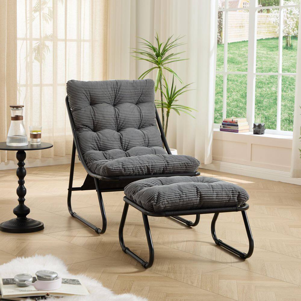 Grey padded lounge chair and ottoman with black frames.