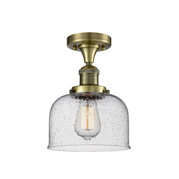 Bell 8 in. 1-Light Antique Brass Industrial Semi-Flush Mount with Seeded Glass Shade