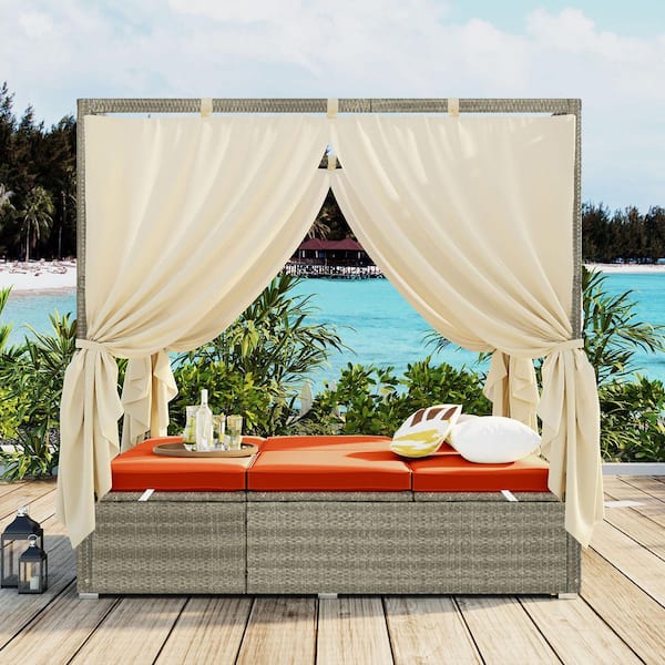 Wicker Outdoor Day Bed with Orange Cushions and Curtain