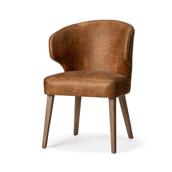 The Niles is a Stylish Wingback Dining Chair Wrapped in Medium-Brown Toned Fabric that Emulates the Look of Leather