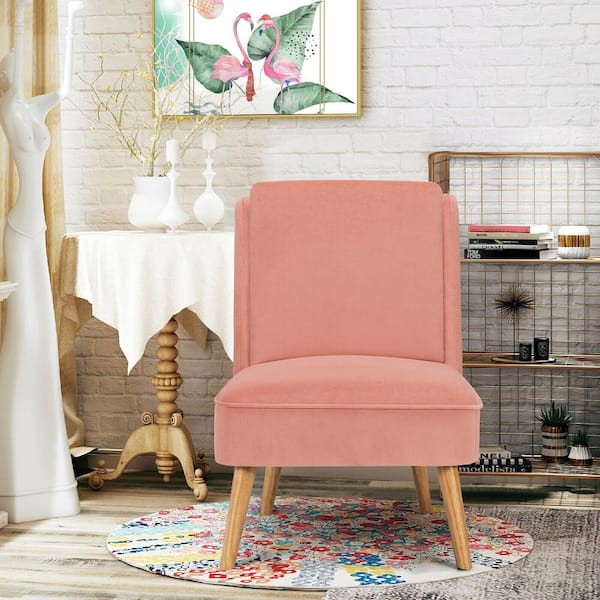 pink velvet chair with wooden legs