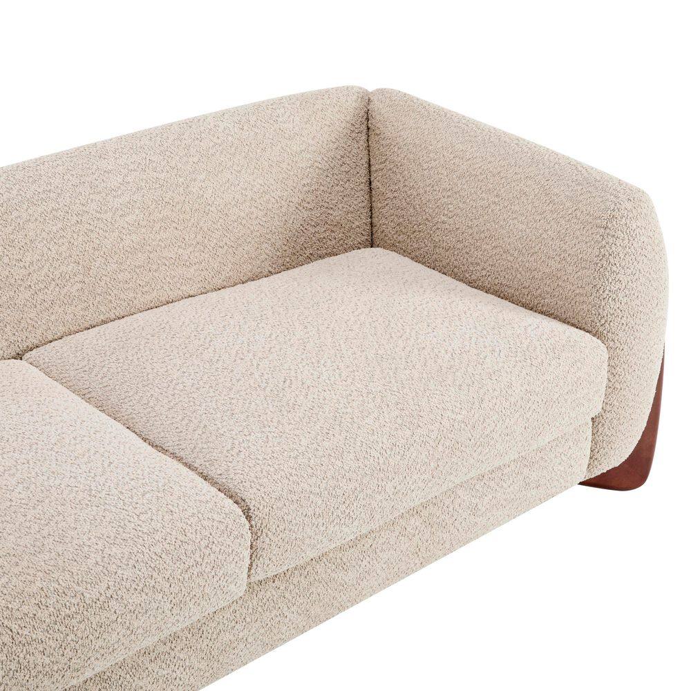 Close-up view of the almond boucle fabric and seat cushions of the sofa.