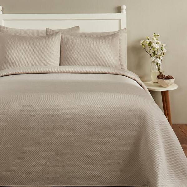 tan and white bedspread
