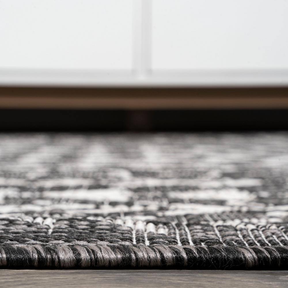 4' x 6' Black and Ivory Geometric Synthetic Area Rug