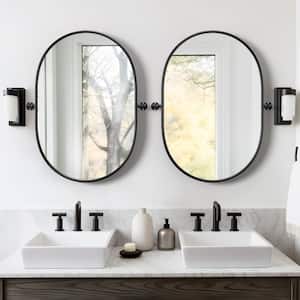 23 in. W x 31 in. H Oval Metal Framed Pivoted Bathroom Wall Vanity Mirror in Black (Set of 2)