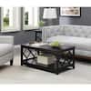 Black rectangular wood coffee table in a living room setting with a grey sofa.