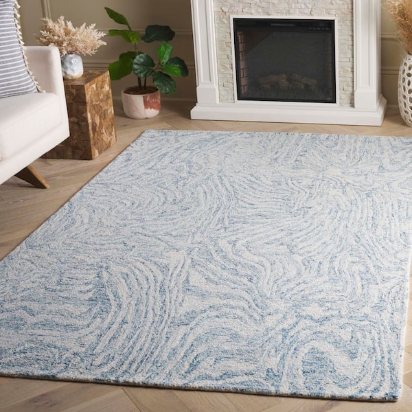 Ebony 6 ft. x 9 ft. Ivory/Light Blue Swirls Abstract Area Rug