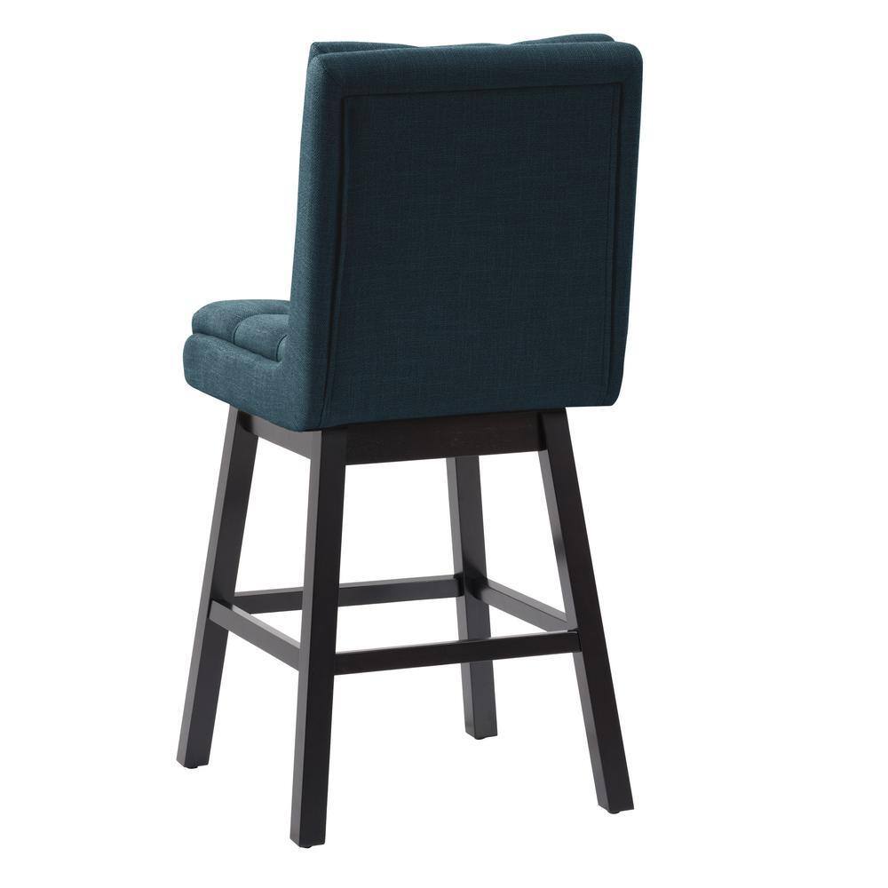 Rear view of a navy blue tufted fabric barstool with black wood legs.