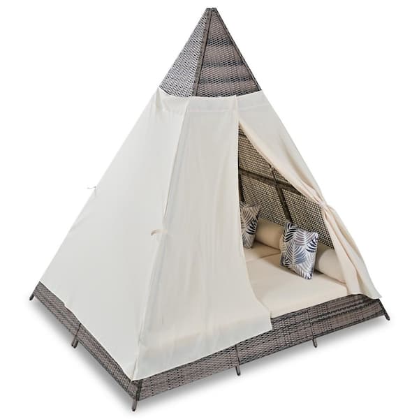 Brown Wicker Outdoor Day Bed with Beige Cushions and Colorful Pillows in Tent Shape