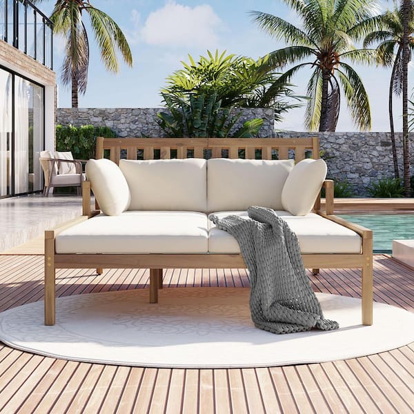 Light Teak Wood Outdoor Day Bed with Beige Cushions and Curved Armrests
