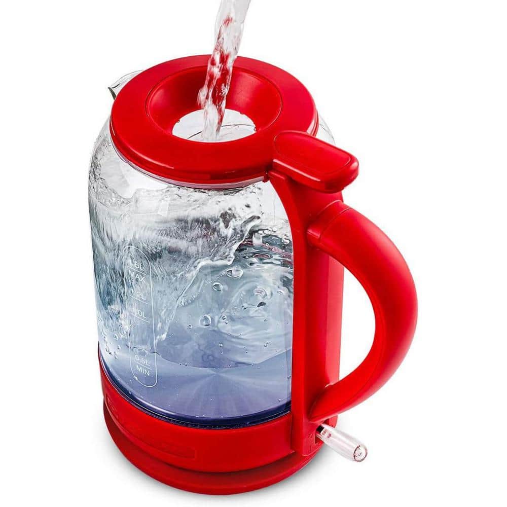 Red tea drink is boiled in a glass kettle on a gas stove, close-up