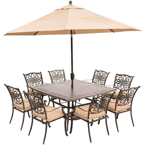 Hanover Traditions 9-Piece Aluminum Outdoor Dining Set with Square Cast-Top Table with Natural Oat Cushions, Umbrella and Base
