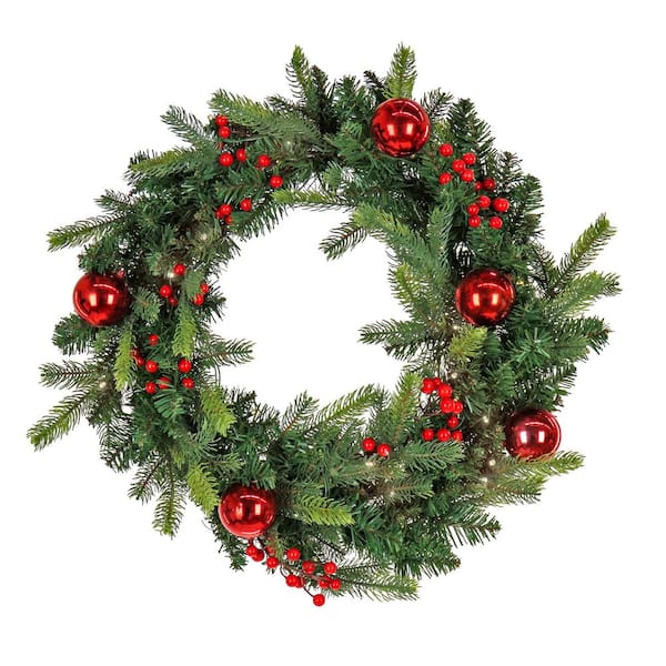 A wreath of Christmas tree branches with a red - Stock