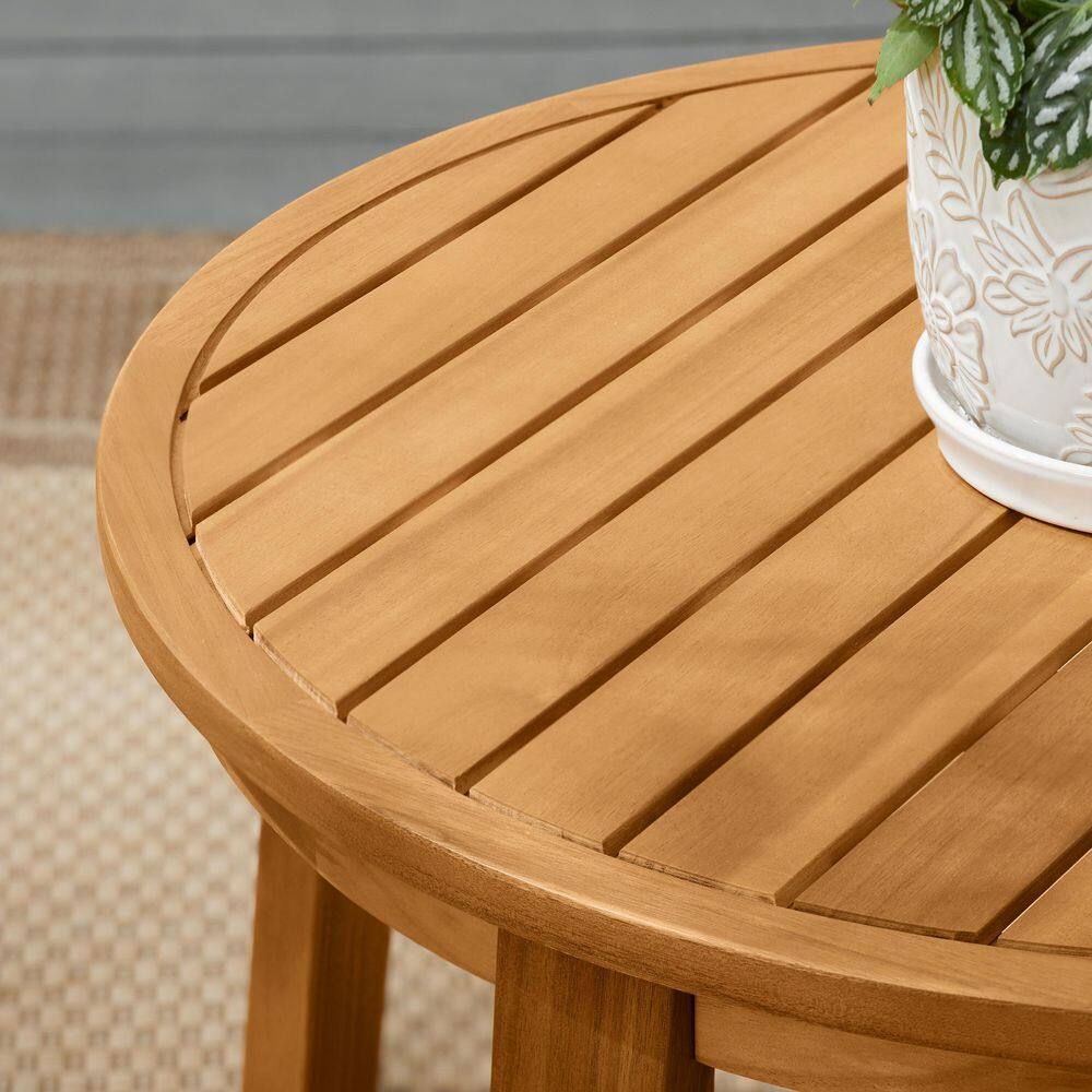 Close-up of round wooden slatted coffee table.