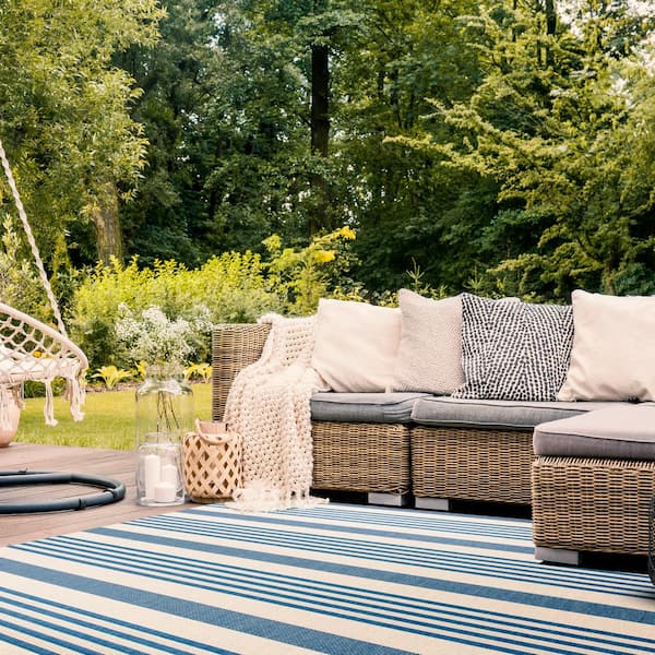 https://images.thdstatic.com/productImages/5a449195-0f9d-4703-ae9b-831d297cb208/svn/beige-blue-safavieh-outdoor-rugs-bhs222m-4-31_600.jpg