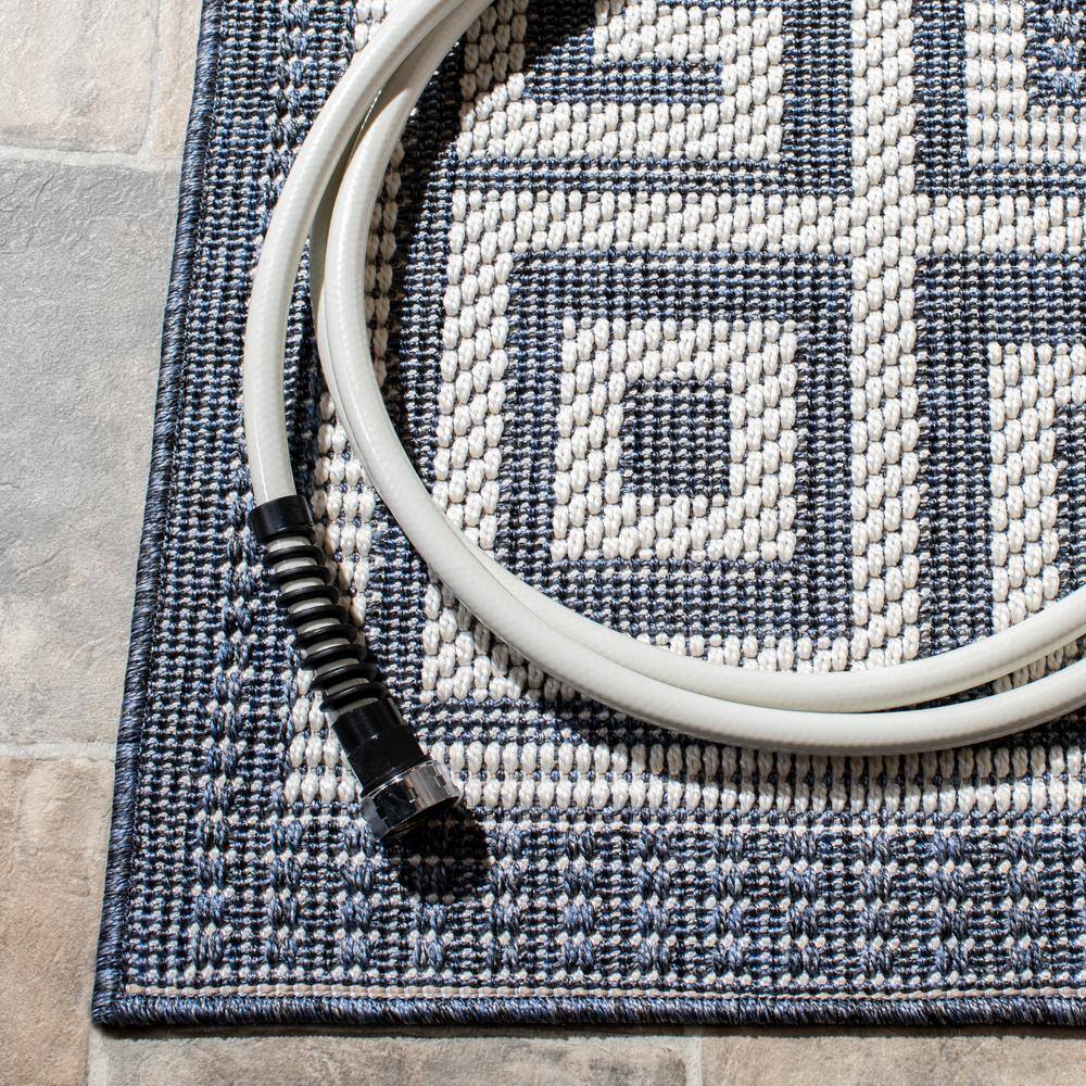 Dark Blue and Ivory Geometric 9' x 12' Synthetic Area Rug