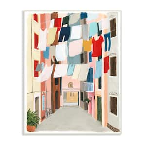 12.5 in. x 18.5 in. "Colorful Laundry Day Clothes Line Between Apartments" by Grace Popp Wood Wall Art