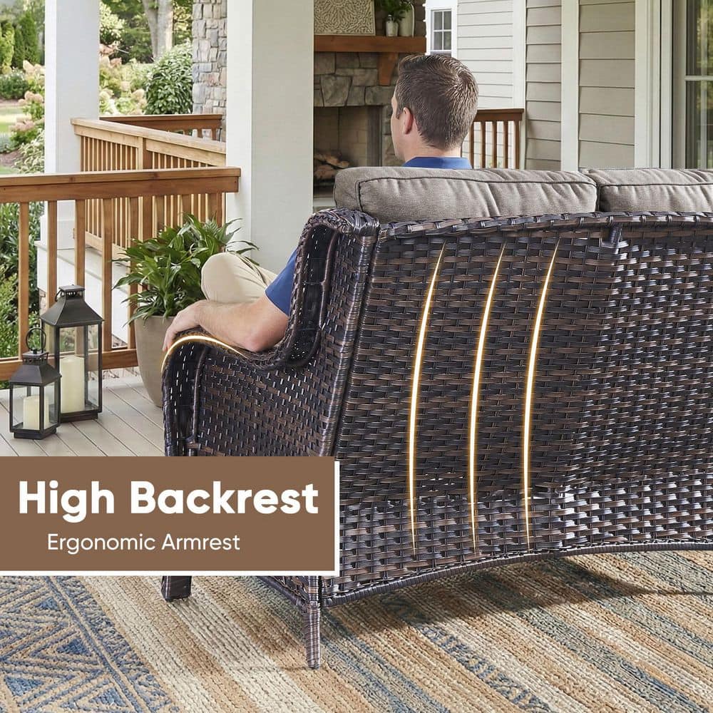 Rear view of a person sitting on a brown wicker loveseat.
