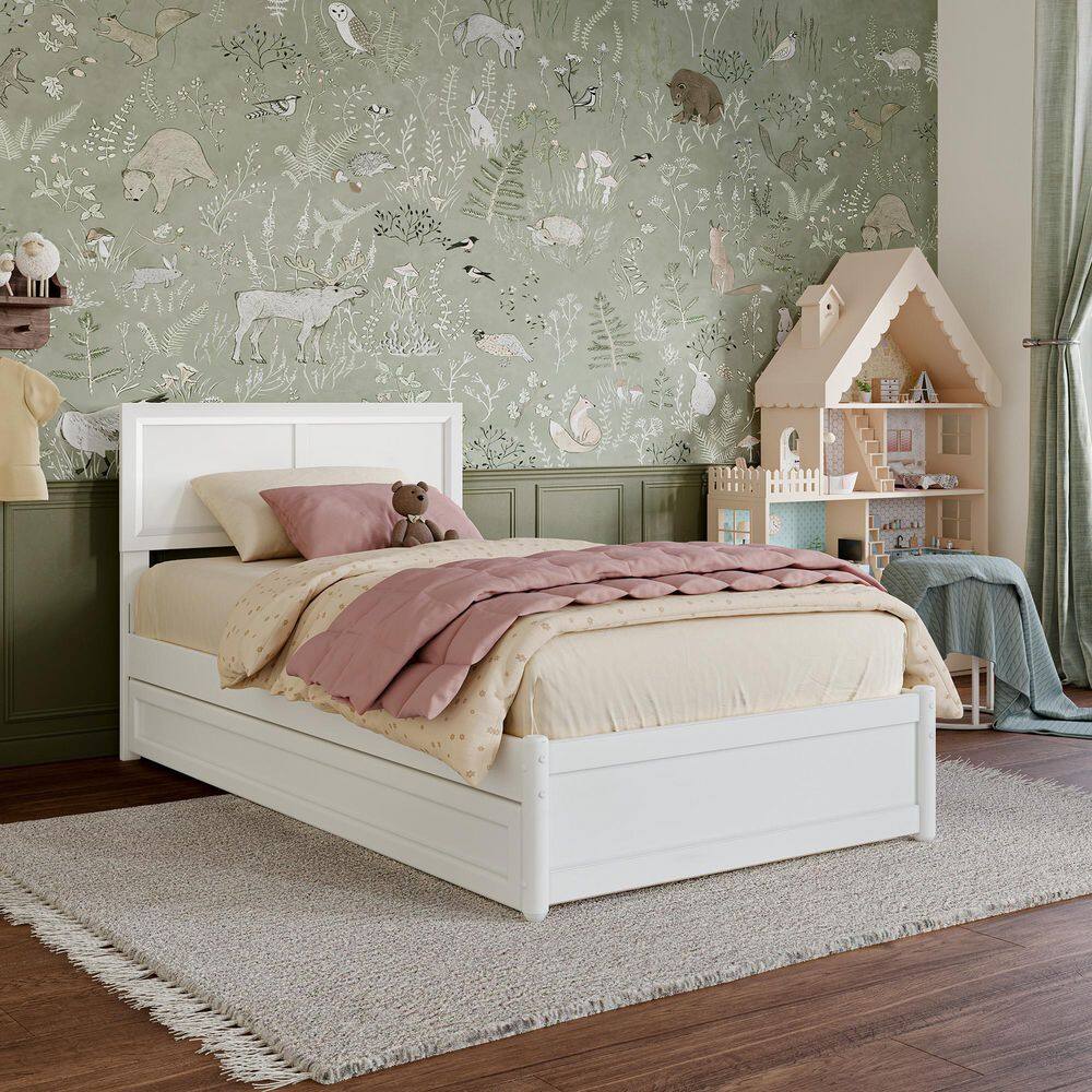 White twin bed with bedding in a styled room.