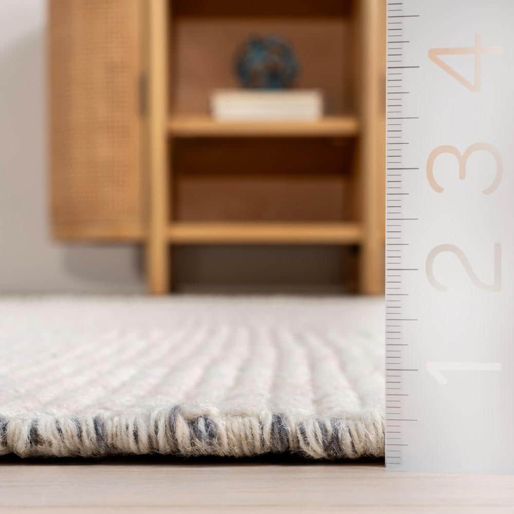Handmade Ivory Wool Rectangular Area Rug with Fringe