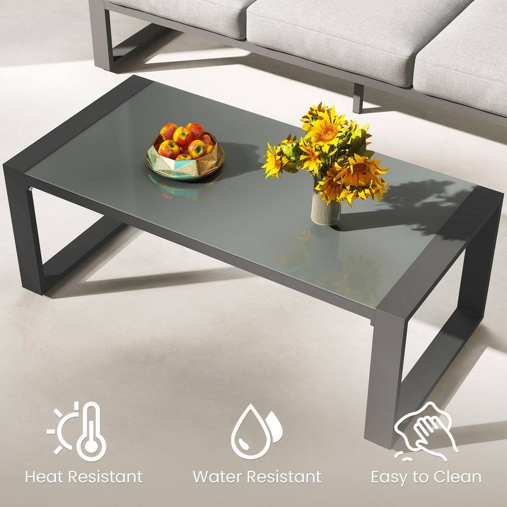 Close-up of a dark gray coffee table with a tempered glass top.