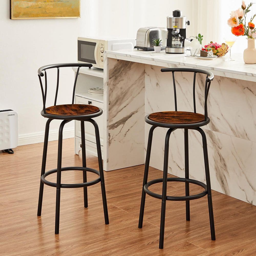 Two black metal bar stools with brown wooden seats at a white marble counter.