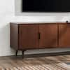 Welwick Designs 58 in. W Walnut Solid Wood TV Stand with Cutout Cabinet Handles (Max TV Size 65 in.)