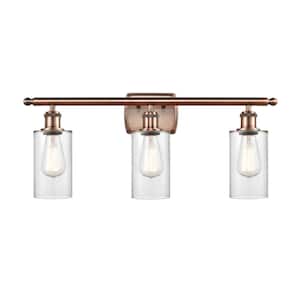 Clymer 26 in. 3-Light Antique Copper Vanity Light with Clear Glass Shade