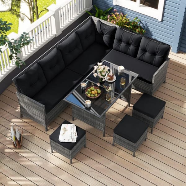 7-Piece Wicker Outdoor Dining Set with Black Cushions and Ottomans