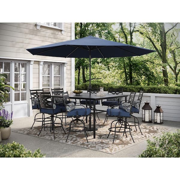 Hanover Montclair 9-Piece Steel Outdoor Dining Set with Navy Blue Cushions, 8 Swivel Chairs, 60 in. Table and Umbrella