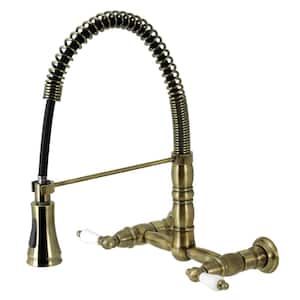Heritage Double Handle Wall Mount Pull Down Sprayer Kitchen Faucet in Antique Brass