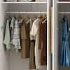 Open wardrobe interior with clothes and shelves.